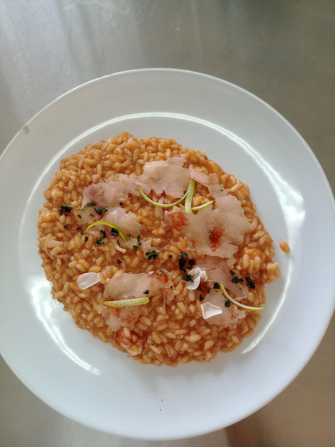Risotto with argentinean prawns, tomato sauce, lime zest, a few jasmine petals and a pinch of parsley.