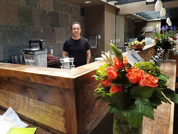 Randy Letter stands behind Saffron's juice bar. Letter owns and operates the new Carson Street restaurant with chefs Arsalan Tavakoli and Shima Tavakoli.