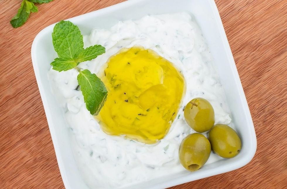 sauce in a white bowl with olives and olive oil