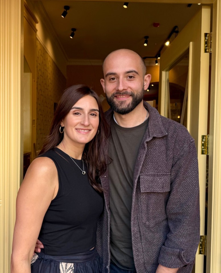 Portrait of a man and woman standing in a doorway.