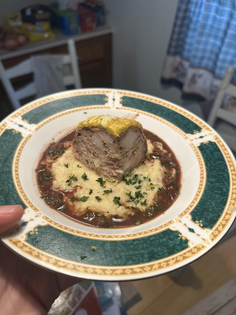 CHOU FARCI - Cabbage stuffed with pork shoulder, pork belly, onion, garlic, and fresh thyme. Rustic Mashed Potatoes, and a Red Wine Sauce finished with fresh herbs.