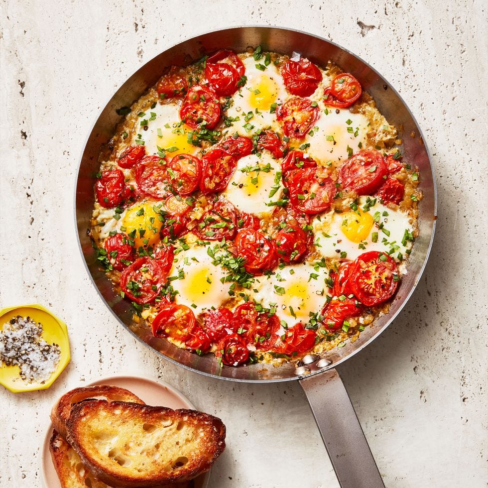 shakshuka in a pan with toasted bread on the side