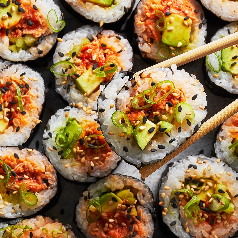 spicy tuna roll with scallions and sesame on top