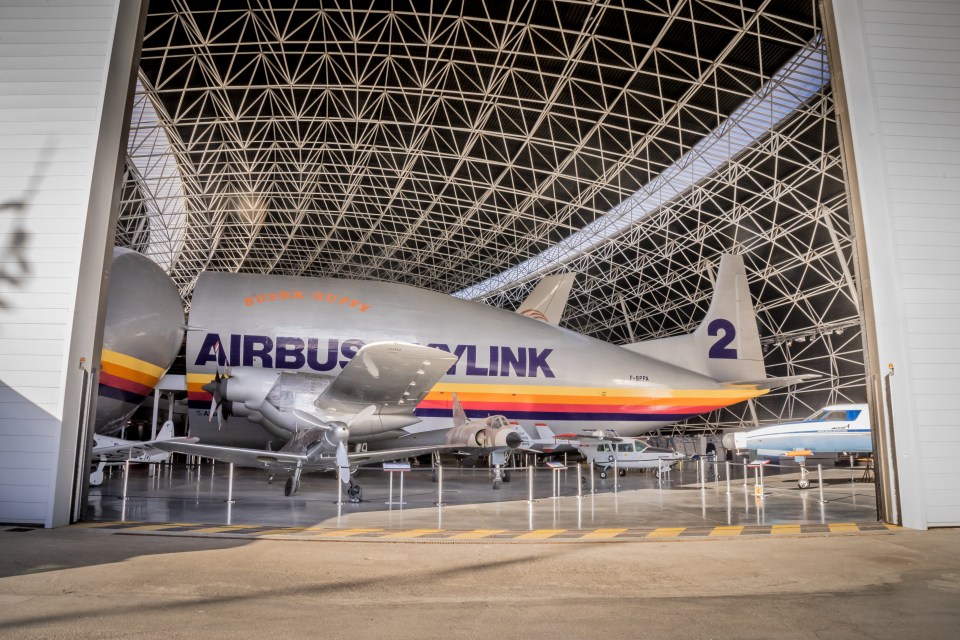 Airbus Super Guppy and other aircraft in a hangar.