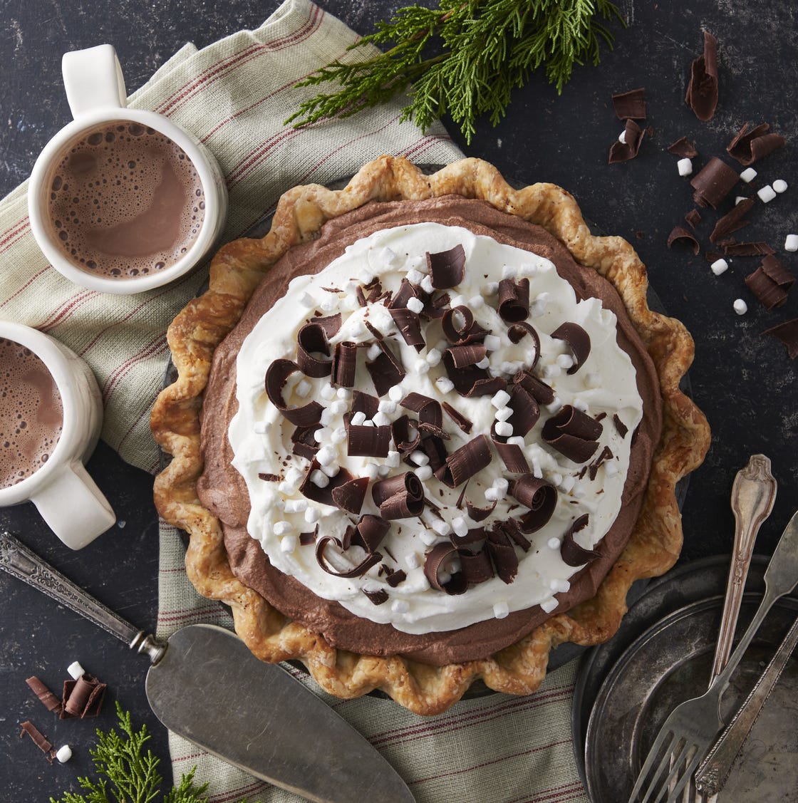 hot chocolate icebox pie topped with whipped cream chocolate curls and mini marshmallows