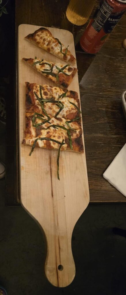 Pizza served on wooden board