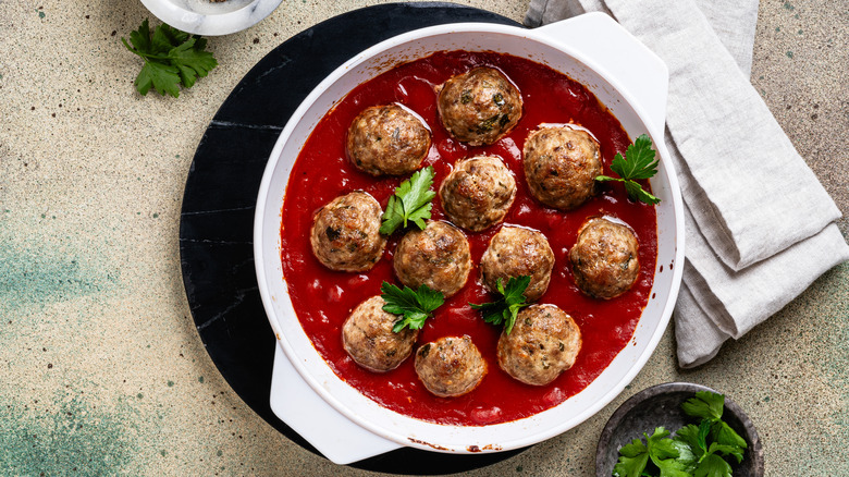 meatballs swimming in tomato sauce