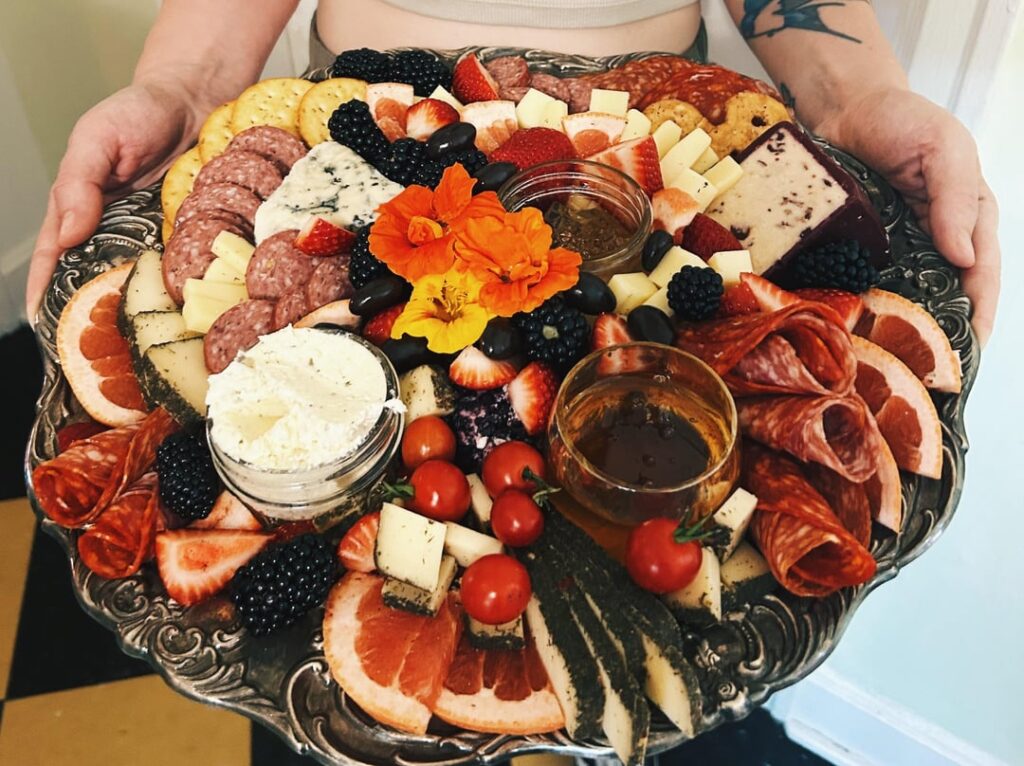 Summer harvest board for a potluck in the park with friends