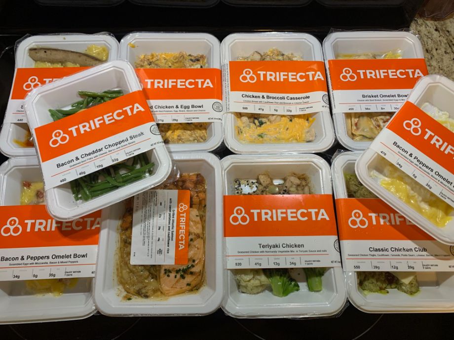 An image of multiple Trifecta Meal Packages stacked on top of each other