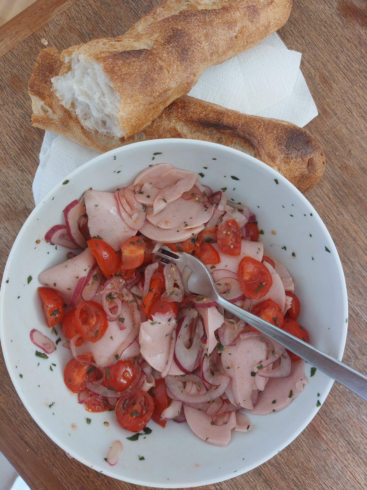 Sausage salad with baguette.