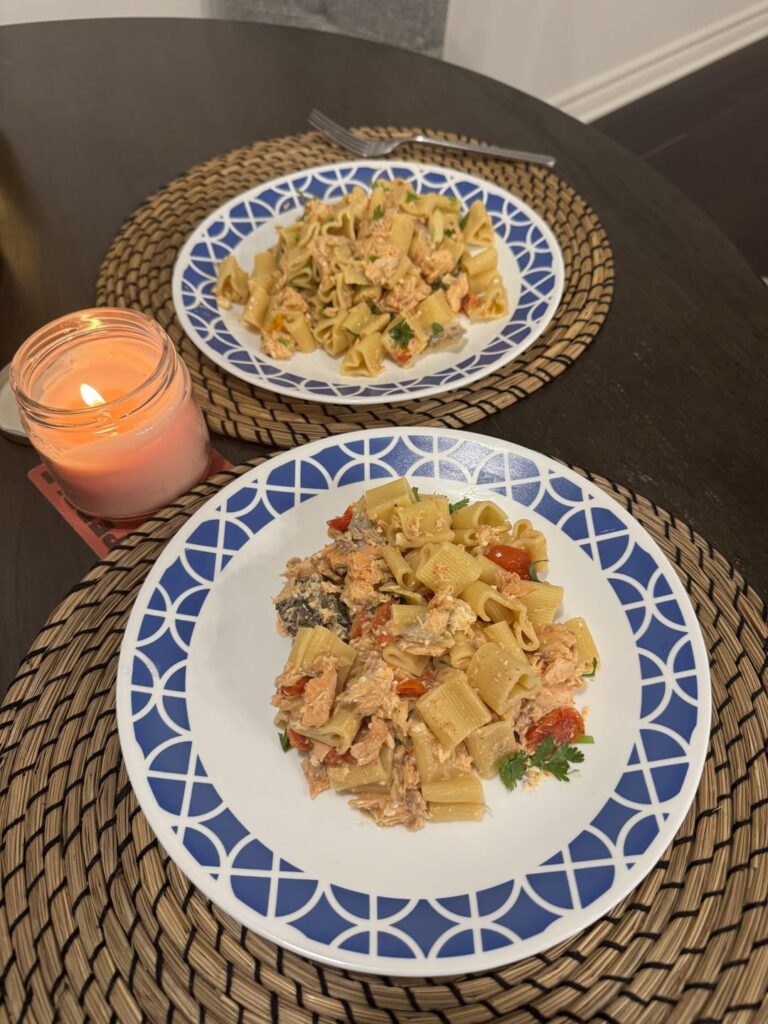 Heart-shaped pasta with roasted salmon, feta, cherry tomatoes, and garlic
