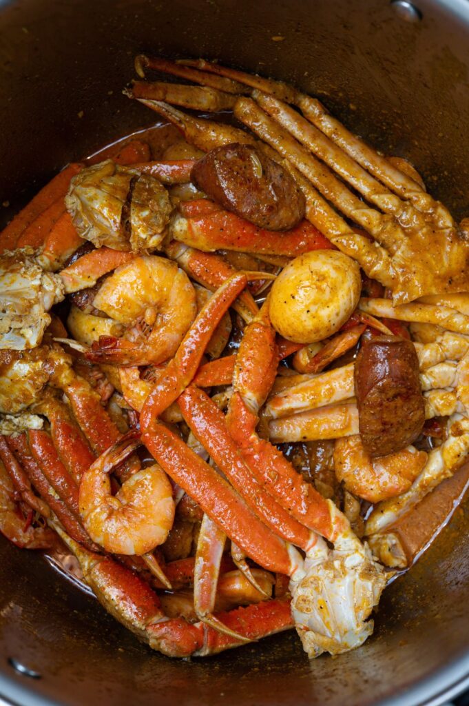 [homemade] snow crab legs, shrimp, sausage, egg and potatoes in spicy garlic butter.