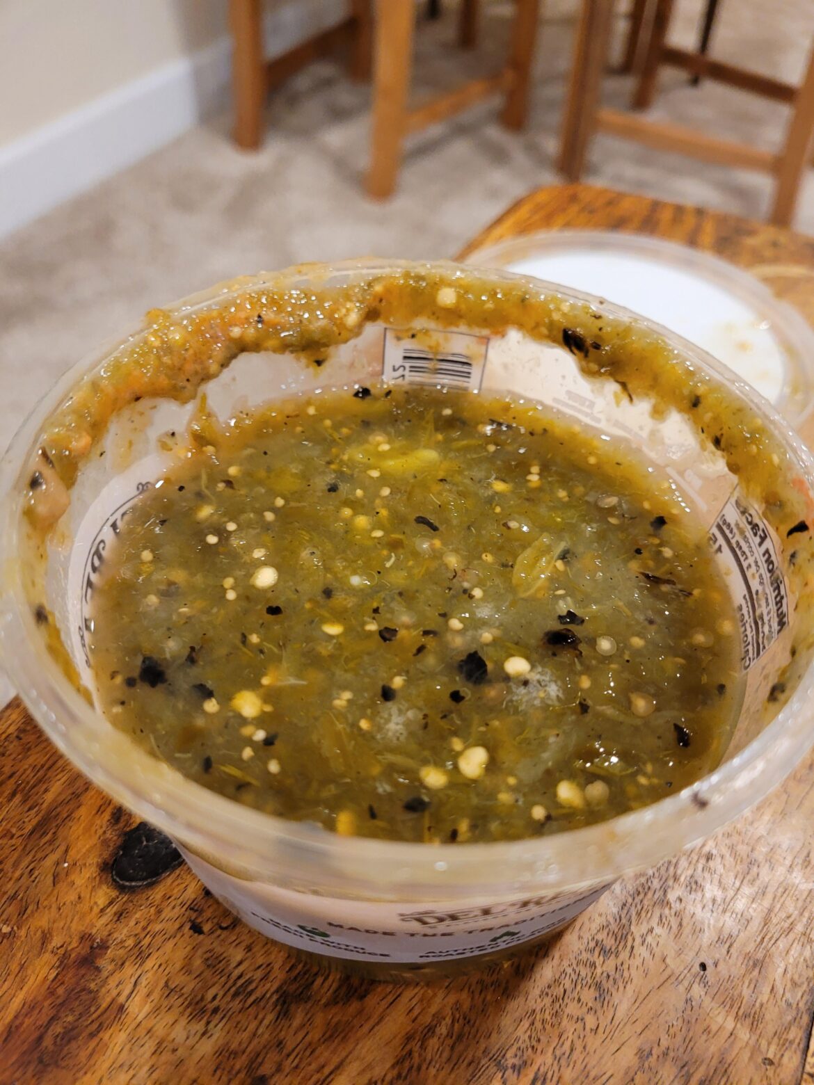 Has this salsa gone bad? It's been in the fridge for only about a week but there's a weird red color around the lid and some white spots.