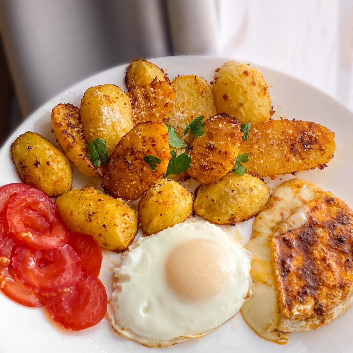 Brie cheese, parmesan potatoes and a sunny side up egg