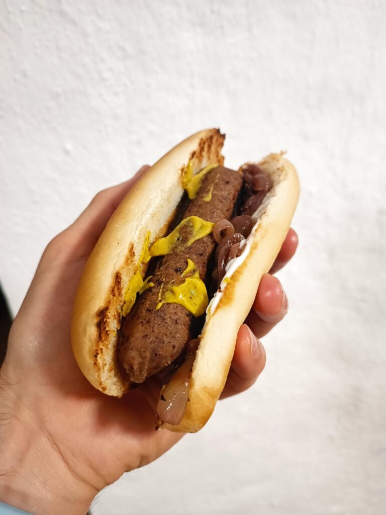 Vegan hot dogs with mayonnaise and stewed onions