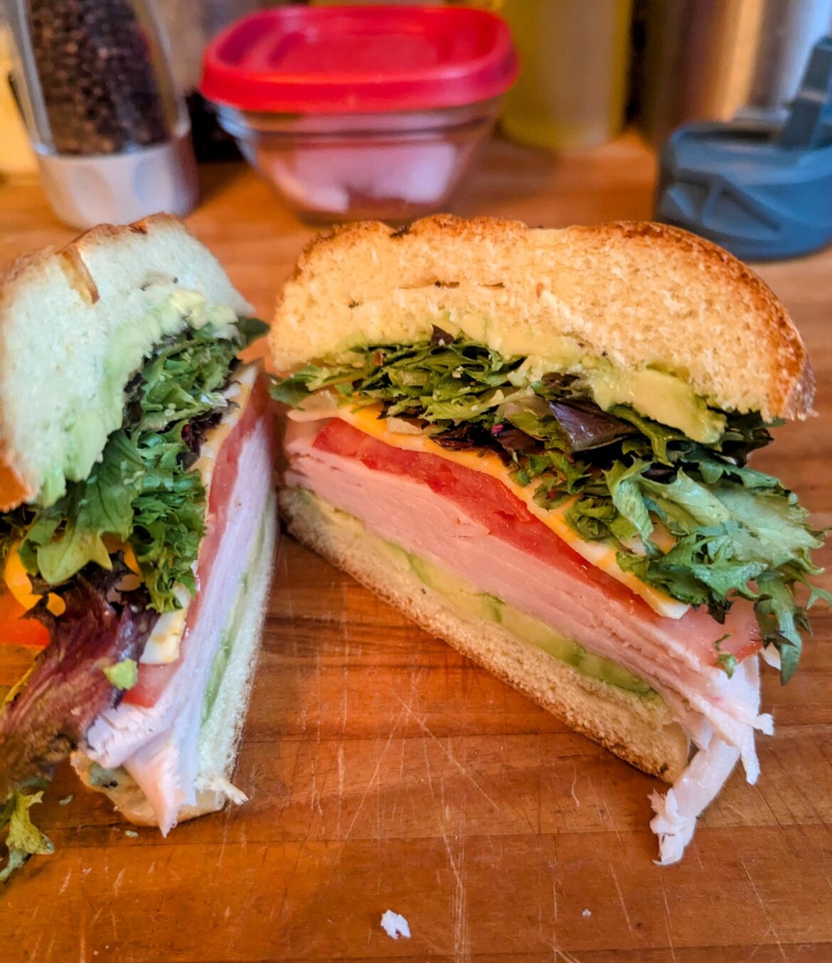 Turkey, avacado, tomato, colby, and greens on a roll