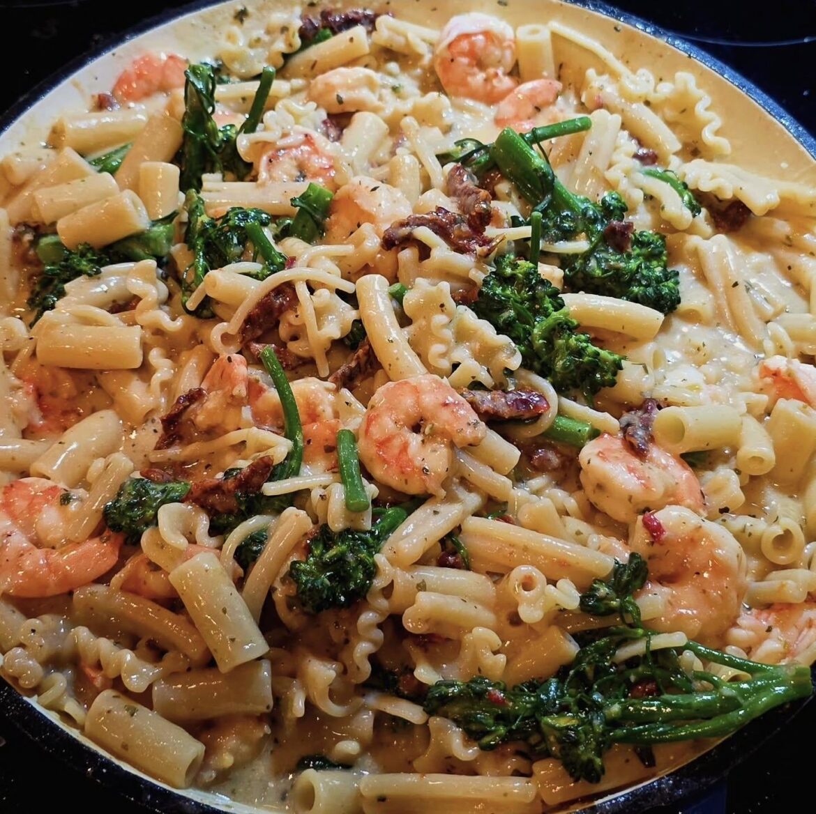 Shrimp with pasta, sun dried tomatoes, broccolini and a cilantro lime cream sauce