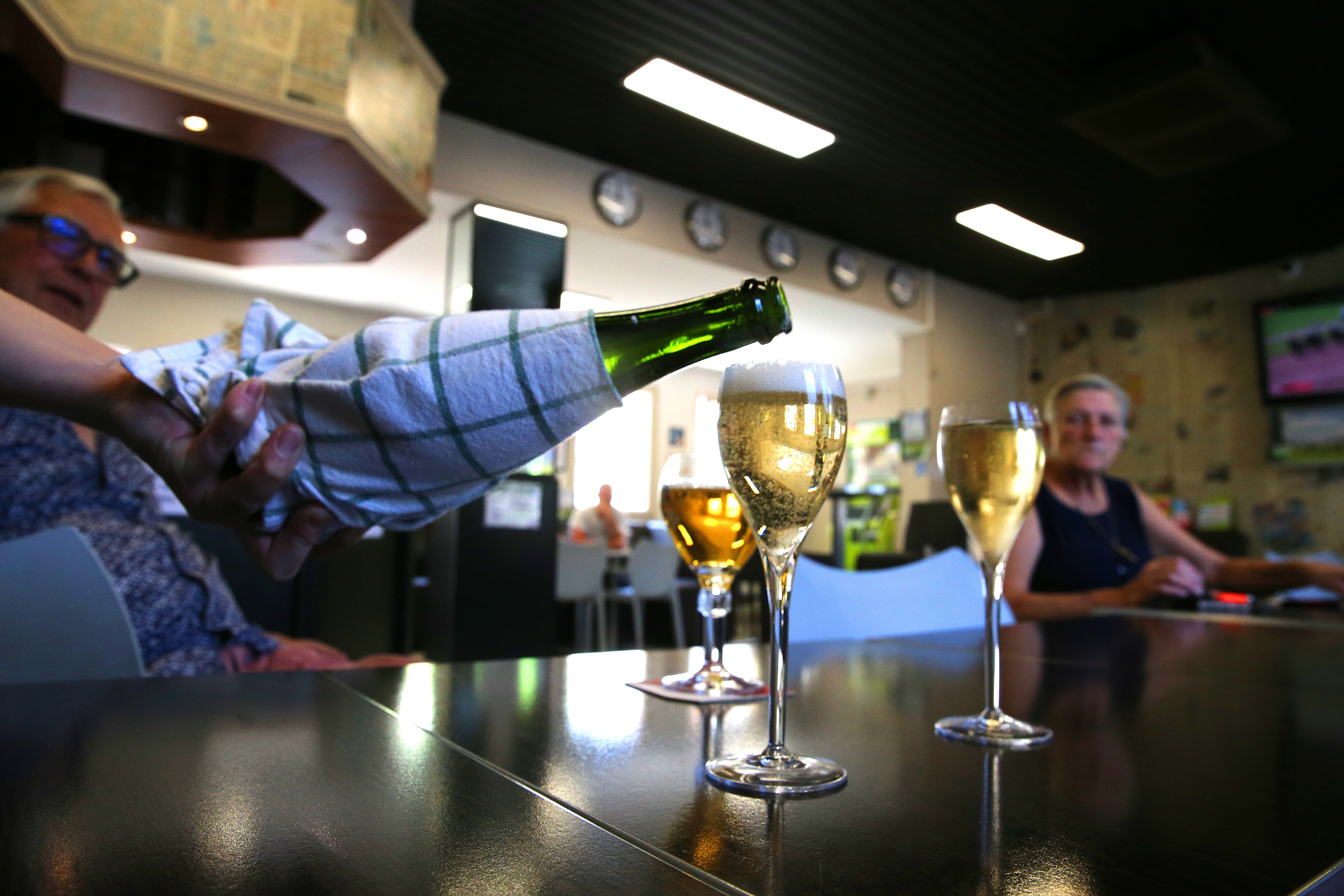 Champagne being poured in a bar.