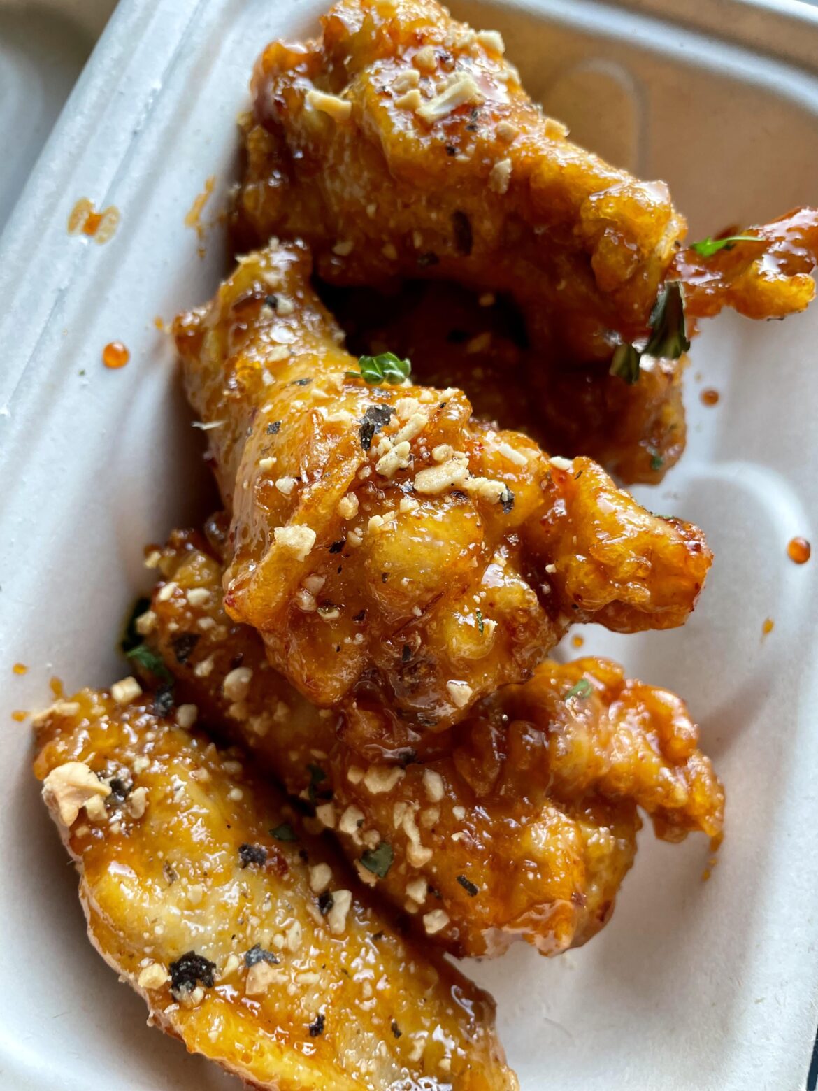 Crabfat Wings. Crab Caramel, Red Curry, Peanuts, Crispy Garlic.