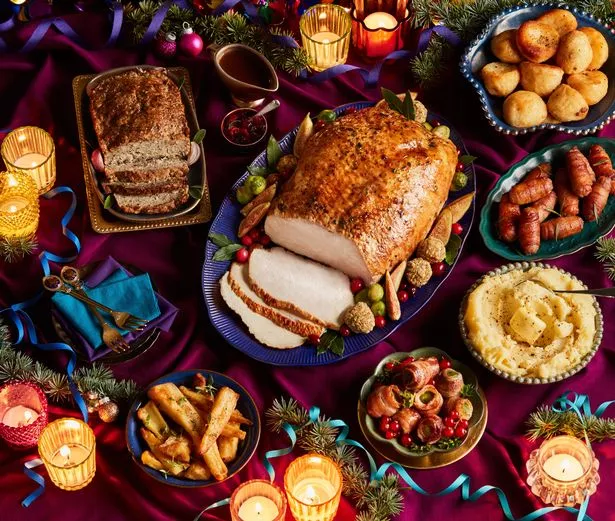 Christmas feast spread with candles on table