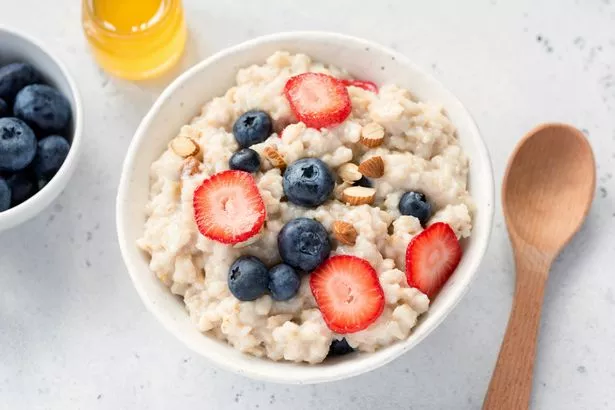 Oatmeal porridge with fresh berries in a bowl. Top view. Concept of healthy eating, healthy lifestyle