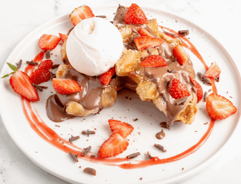 Strawberry and chocolate waffles with vanilla ice cream