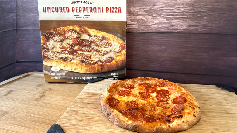 trader joe's pepperoni pizza on cutting board with box