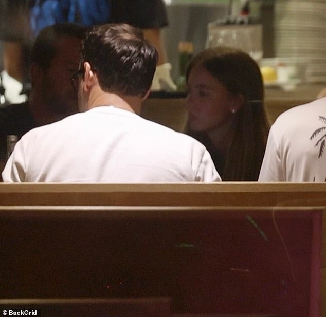 The talent manager, who used to work with Justin Bieber, had on a white long-sleeved T-shirt with his hair cut short and black prescription glasses on