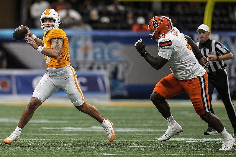 AP photo by Mike Stewart / Tennessee quarterback Joey Aguilar prepares to pass under pressure from Syracuse defensive lineman Dion Wilson Jr. on Aug. 30, 2025, during the Aflac Kickoff Classic in Atlanta's Mercedes-Benz Stadium.