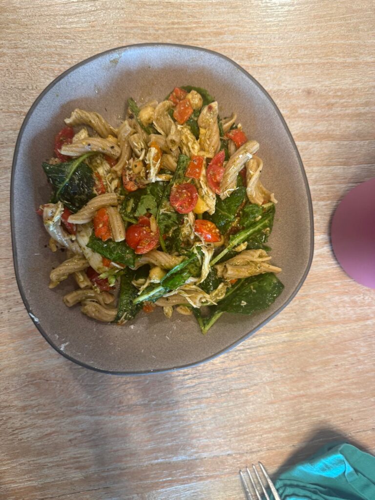 Pesto torchiette with chicken, chickpeas, baby kale, cherry tomatoes, and roasted peppers