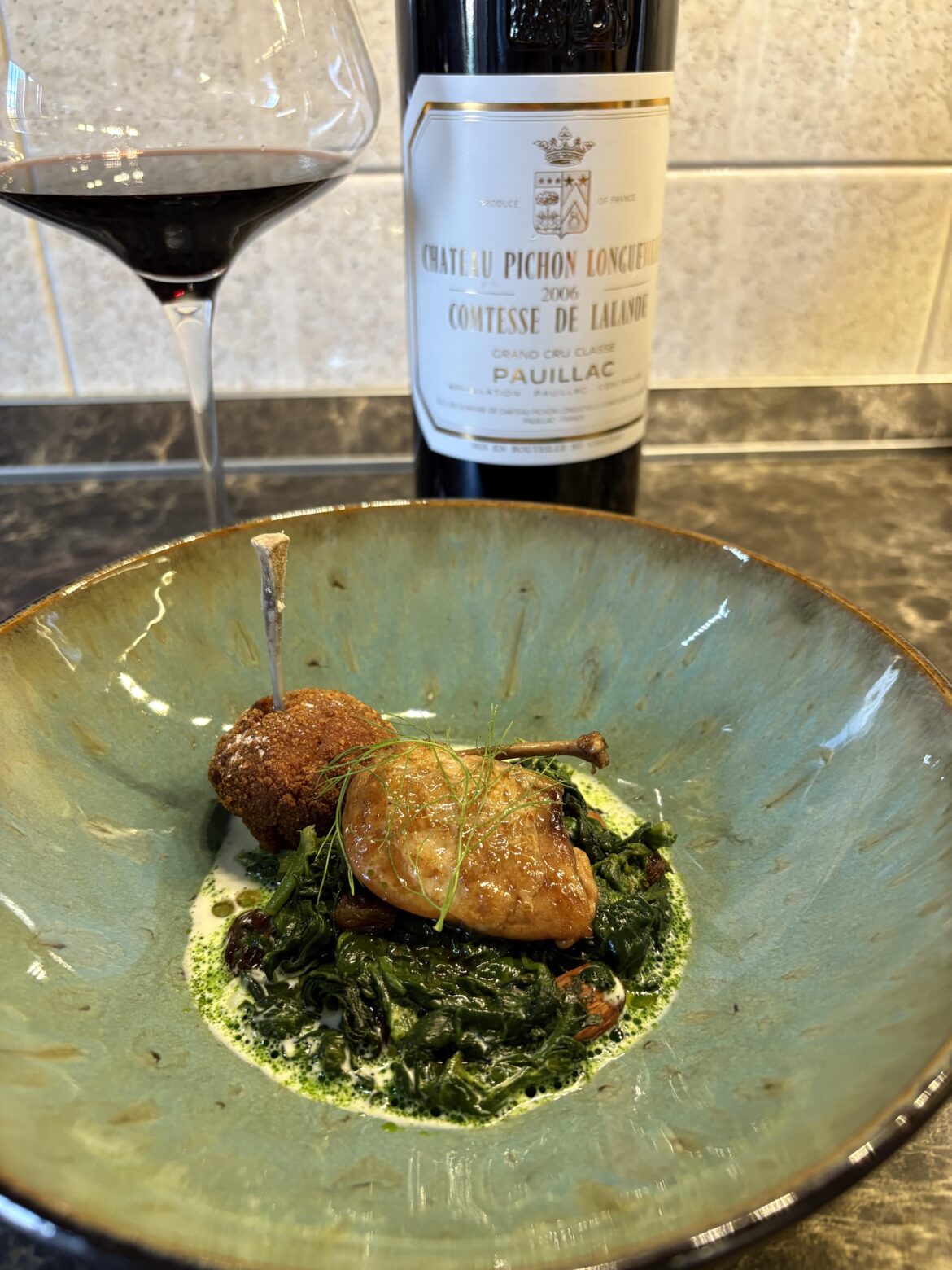 Marsala-glazed quail breast, paired with a crispy fried spiced quail bonbon, served over sautéed spinach with raisins and toasted almonds