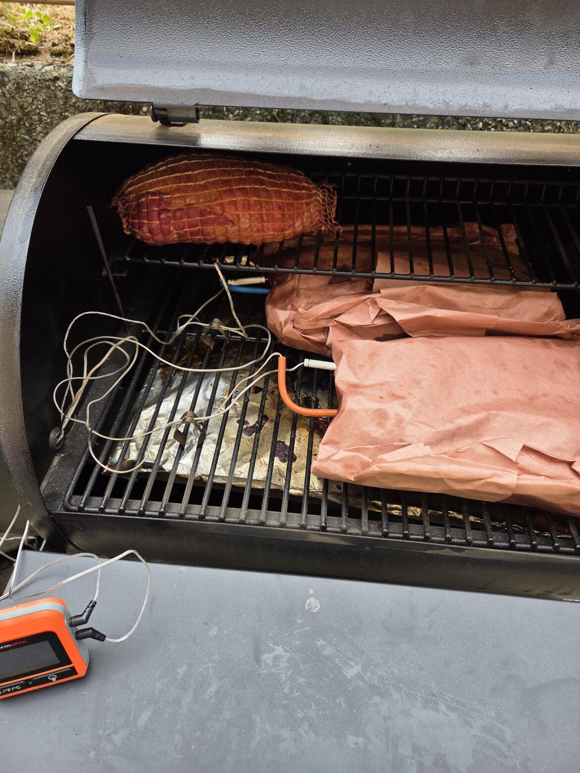 Smoker with brisket and lamb