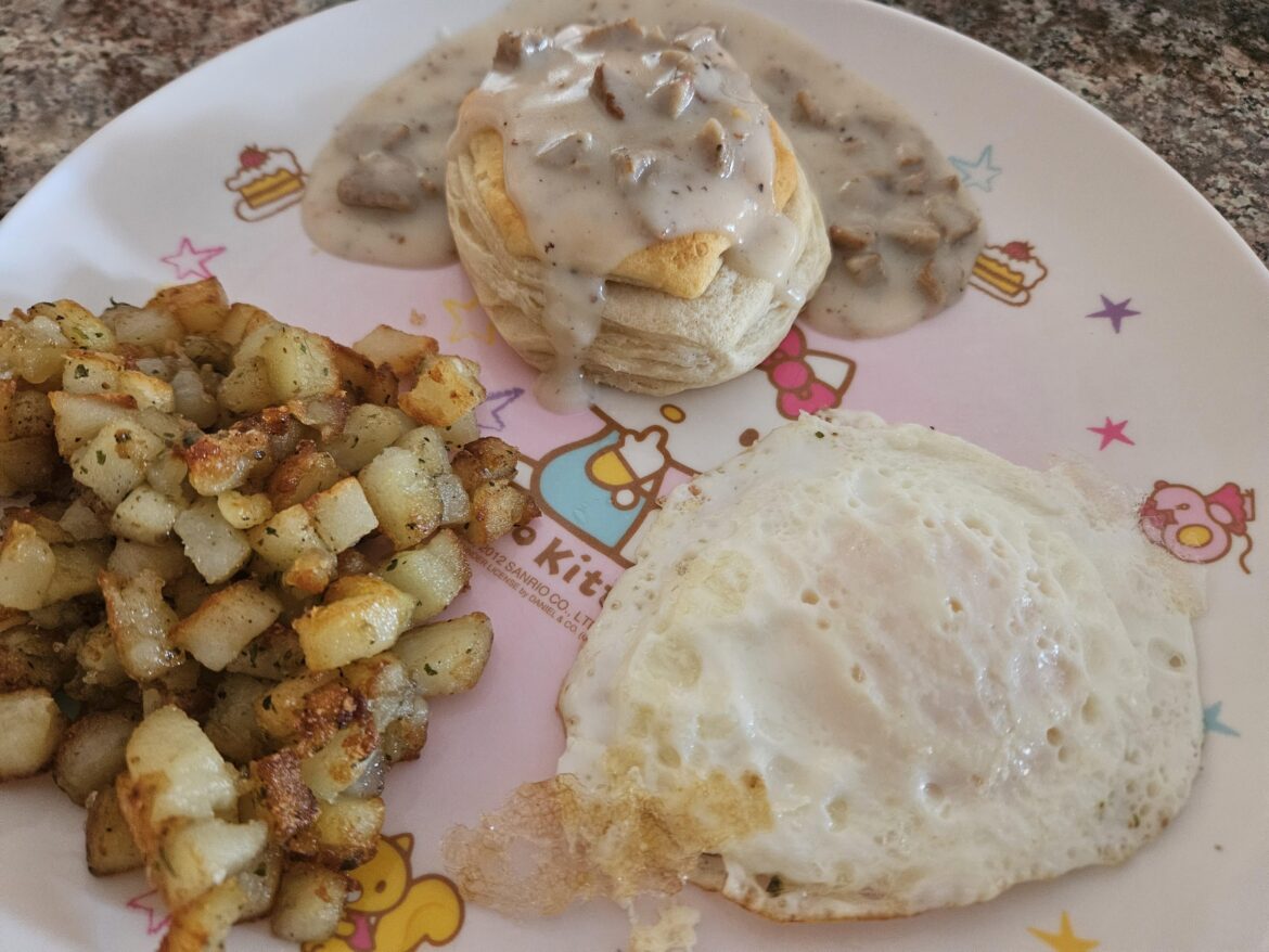 Potatoes, biscuits, country sausage gravy, and an egg...