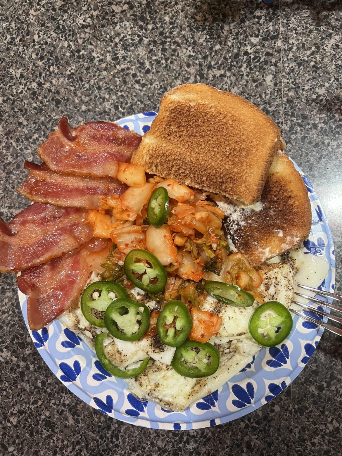 Kimchi, 3 fried eggs, bacon, jalapeños, toast.