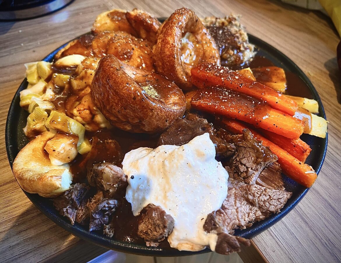 Roast dinner: slow cooked topside of beef with red wine gravy.