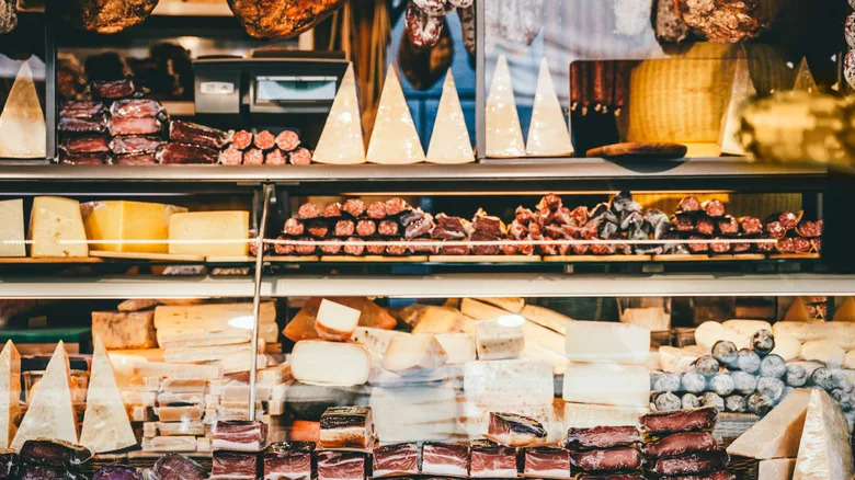 Retail counter with cheeses and cured meats