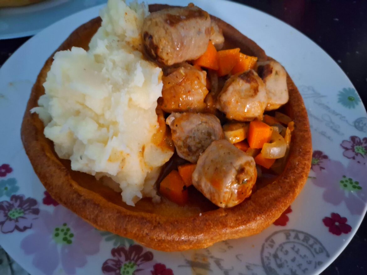 Sausage casserole in a giant Yorkshire pudding