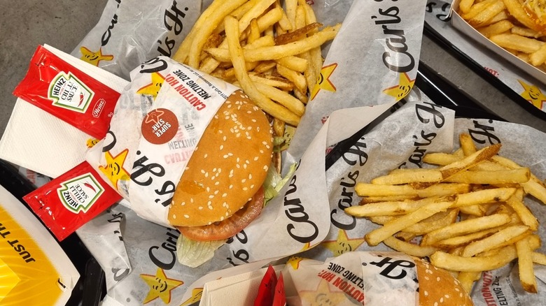 A plate of burgers and fries from Carl's Jr.