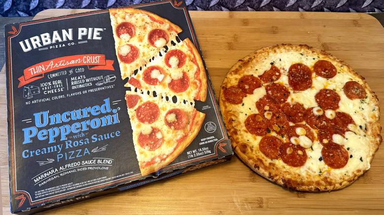 urban pie pepperoni pizza on cutting board with box