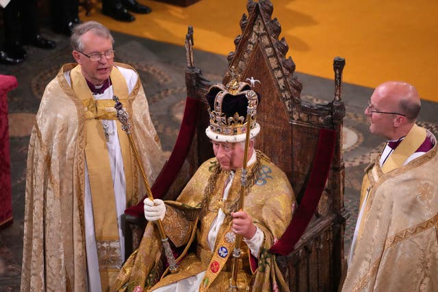 The King, head of the Church of England, after being crowned with St Edward’s Crown in May 2023