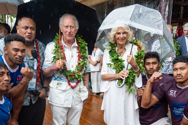 Charles and Camilla with members of the Apia rugby team rugby team during a visit to the Samoan Cultural Village in Apia in October
