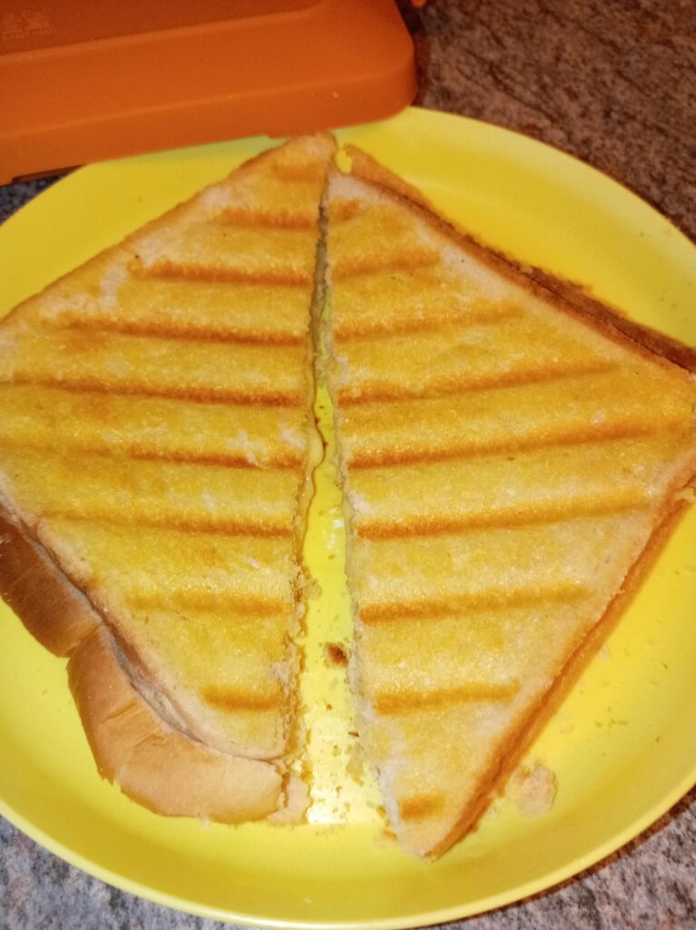 Grilled cheese (AKA toastie in the UK) made using a microwave toastie maker. Made with mature cheddar cheese.
