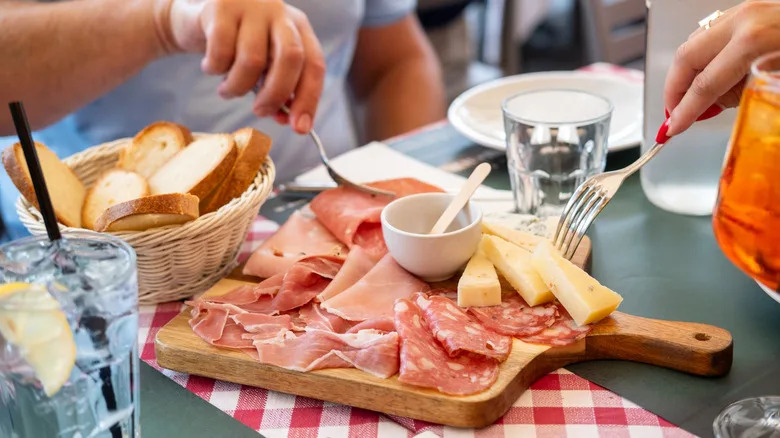 cheese and meat antipasti with bread and a spritz