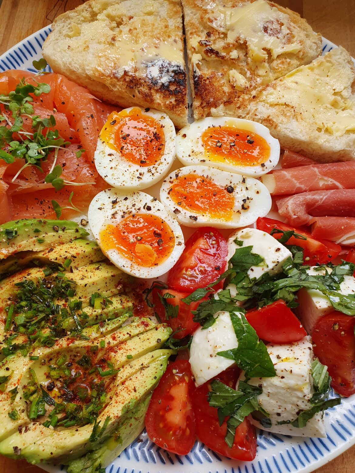 [I ate] smoked salmon with avocado, soft boiled eggs, mozarella salad, pida bread and serrano-edam rollitos
