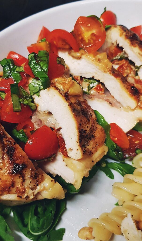 Homemade - Buttermilk Chicken Breast Stuffed with Prosciutto, Sundried Tomato, Basil and Mozarella, Topped with Balsalmic Bruschetta, Served with Simple Caprese Pasta and Rocket.