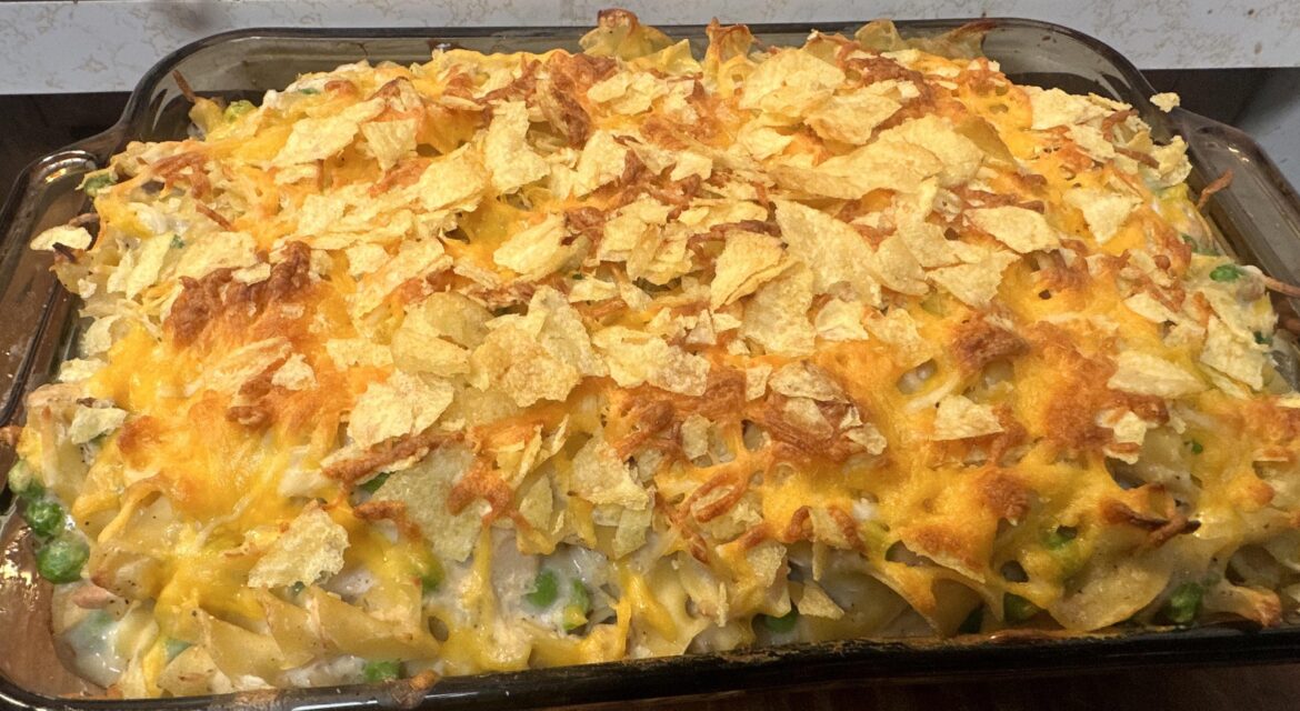 Tuna and noodle casserole topped with Lays potato chips and cheese. Tuna and noodle casserole topped with Lays potato chips and cheese.