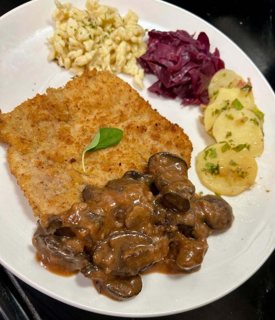 Florida girl made a feast. Homemade Jägerschnitzel with mushroom gravy, braised red cabbage, warm potato  salad, Spätzle and then apple strudel and whipped cream