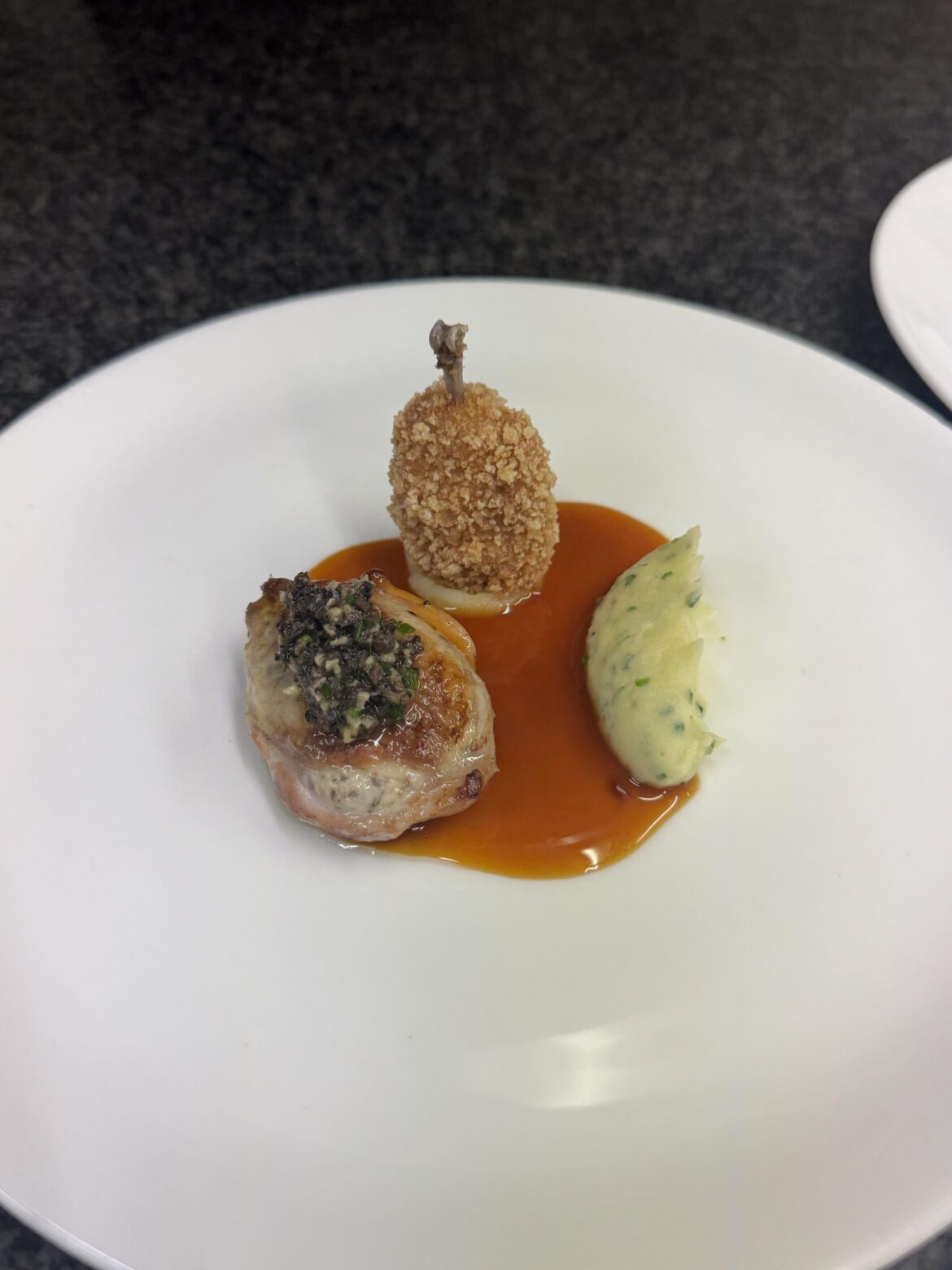 Quail “pop” with quail breast, truffle gremolata, chive potato purée, and a deep quail jus.