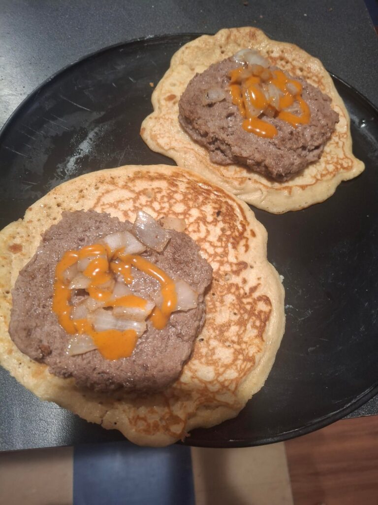 Invention of mine, pancake with burger, onion and buffalo sauce, straight 🔥