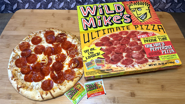 wild mike's pepperoni pizza on cutting board with box